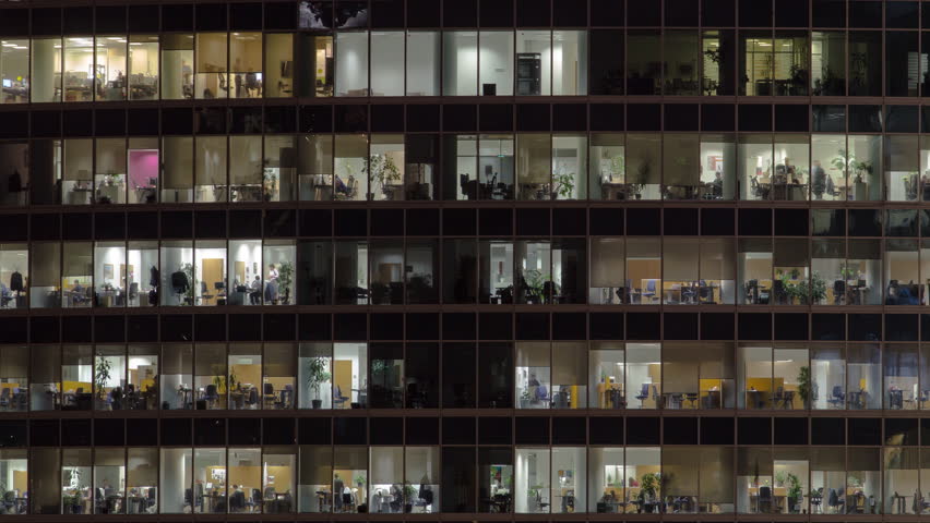 Close view to office windows in Skyscrapers International Business Center City at night with Moscow river timelapse from top, Moscow, Russia. Zoom out