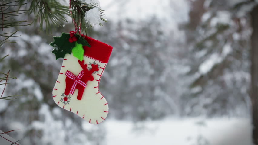 sock and mittens with Christmas pattern hanging and dying on the clothesline