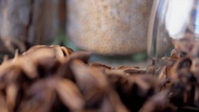 Close up footage of star anise spice on wooden board. Selective focus. Tracking shot.