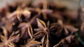 Close up footage of star anise spice on wooden board. Selective focus. Tilt down shot.