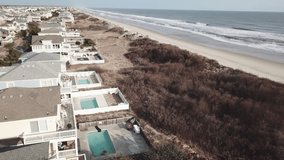 Aerial drone shutting video with beach and houses from Corolla North Carolina 