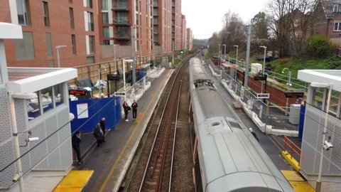 WEST HAMPSTEAD, LONDON - JANUARY 11, 2019: View over a train departing the platform at West Hampstead Overground Station in London, UK.