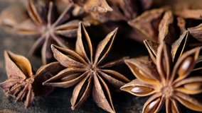 Close up footage of star anise spice on wooden background. Selective focus. Tilt up shot.