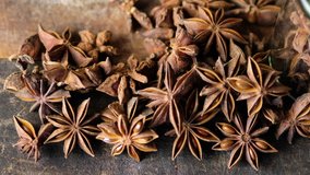 Close up footage of star anise spice on wooden background. Selective focus.