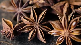 Close up footage of star anise spice on wooden background. Selective focus. Panning to the right.