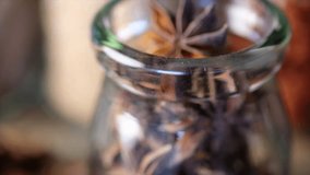Close up footage of star anise spice on wooden background. Selective focus. Panning to the left.