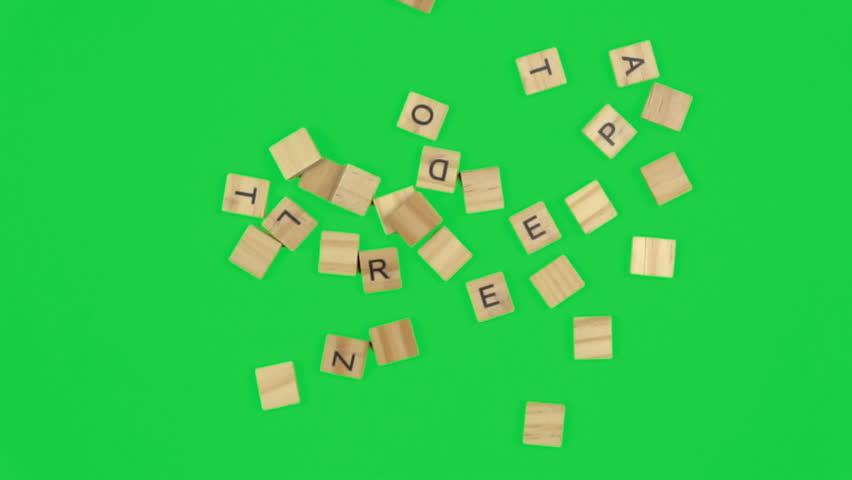 Random letters on wood tiles scattering then spelling the word LOVE; closeup; chromakey