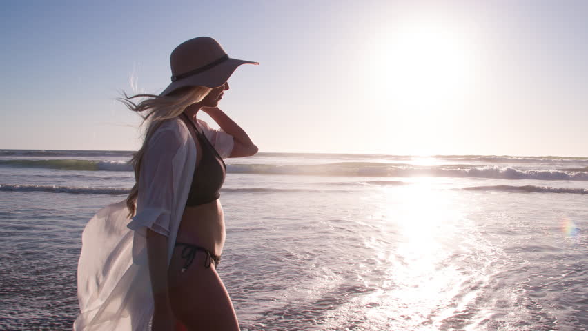 Attractive Blond Woman Walking on the Beach  | Shutterstock HD Video #1023408958