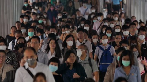 BANGKOK THAILAND, 30 Jan 2019, Time lapse crowd people wearing face mask for protect micro dust in air when go to their workplace during pm2.5 air pollution and coronavirus crisis in Bangkok morning.