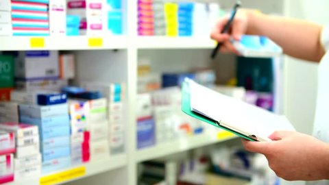 Pharmacist filling prescription in pharmacy drugstore