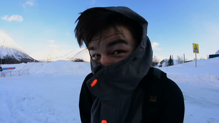 Man is standing on the street and freezing in cold weather close up