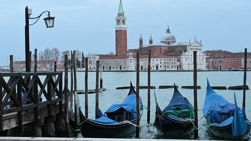 Gondolas and other boats at dusk in the basin of San Marco