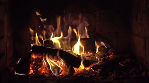 A fire burns in a brick fireplace, keep warm