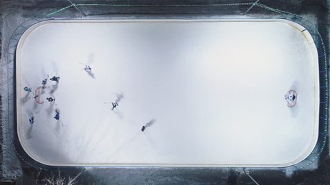Players on Ice Rink Playing Hockey. Aerial Vertical Top-Down View. Static Drone Shot