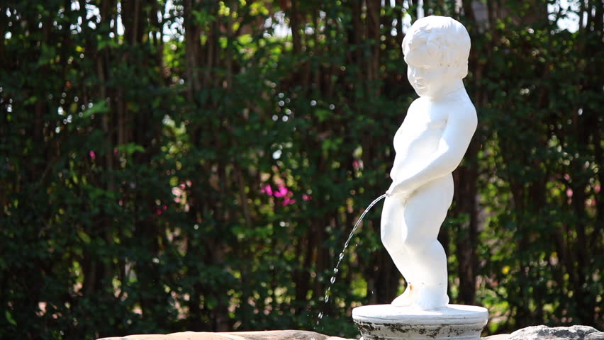 Manneken Pis symbol show in the garden with copy space for text