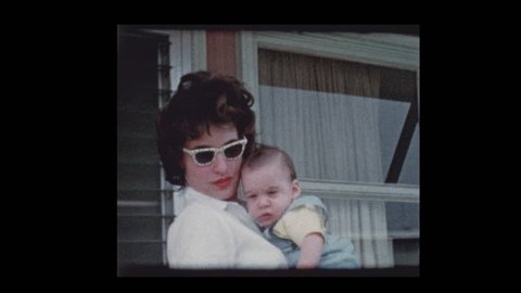 1959 Stylish Women wearing sunglasses holding cute infant baby boy