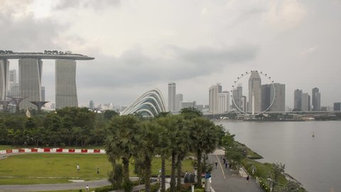 Time lapse of sunset at Marina Bay Singapore city skyline. Pan left