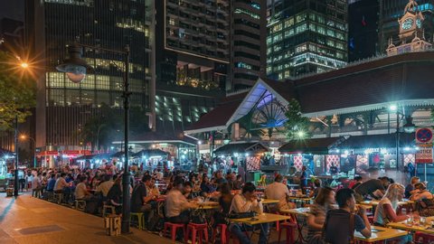 2019-09-05 | 4K Timelapse Sequence of Singapore, Singapore - The Downtown outdoor food court at Night (side view)