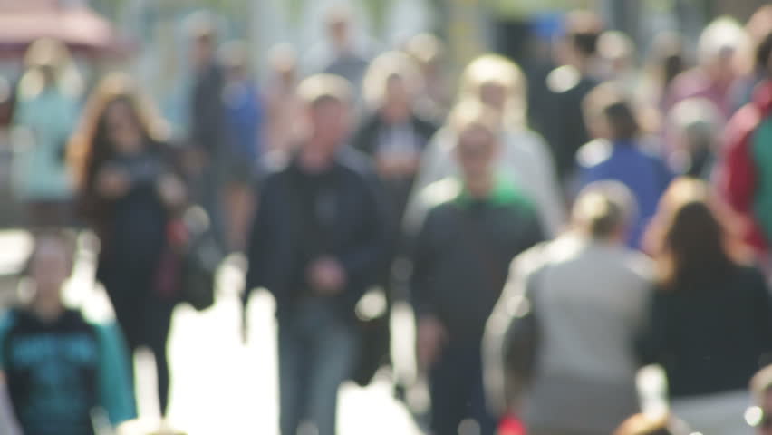 Crowds on crosswalk. Anonymous people walking down the street.  Defocused Full HD shot, high angle.