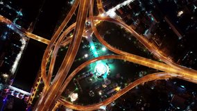 Hyperlapse timelapse of night and day city traffic street intersection circle roundabout in bangkok, thailand. 4K UHD horizontal aerial view