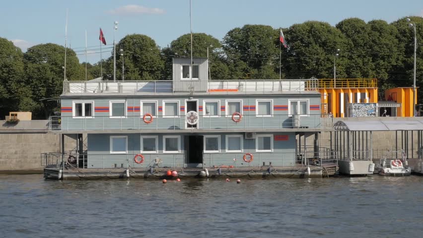 View from boat on wooden lifesaving station on Moskva river embankment near Gorky Park in Moscow, Russia