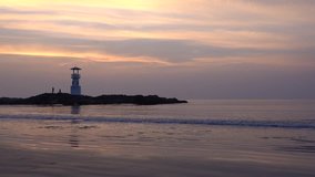 Video of small lighthouse against a tropical ocean sunset and smooth water at Khao Lak Beach in Phang Nga,Thailand. English translate;Khao Lak light beacon.