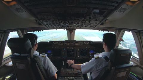 cockpit view of airline pilot control aircraft in daytime,commercial pilot landing the aircraft ,4K footage 