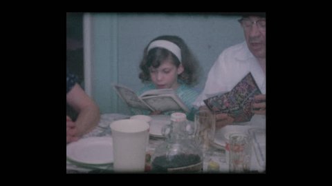 1961 Jewish family reads Haggadah at Passover Seder