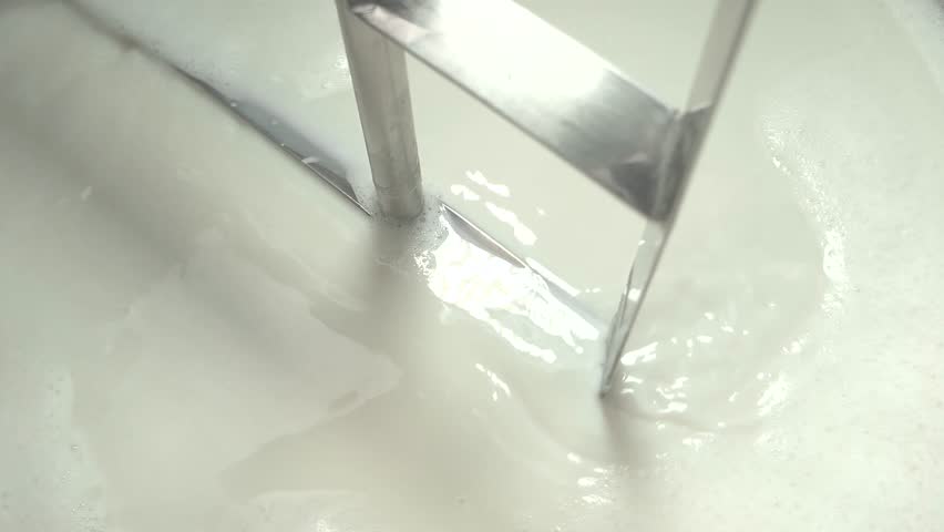 Cheese manufacturing process. Huge tank for storing and fermenting milk at a dairy factory. Close up of mixing milk in a large stainless steel tank. Food industry. Royalty-Free Stock Footage #1023474673