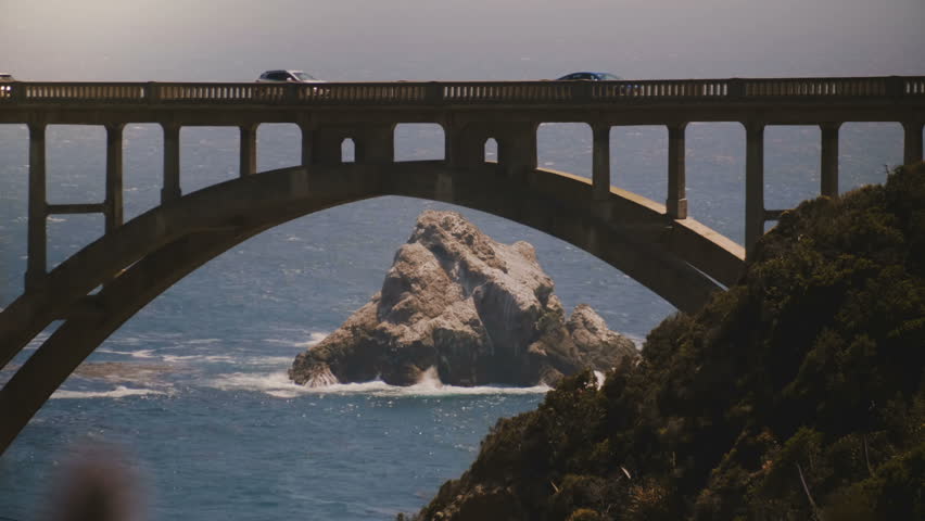 Atmospheric close-up shot of iconic Bixby Canyon Bridge, Highway One and Pacific Ocean coast in Big Sur California USA.