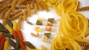 VIDEO, I love pasta text from pasta letters, rotating on white plate
