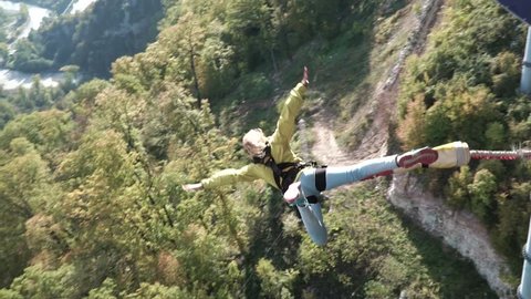 Girl has an amazing time bungee jumping in Sky Park/ Exploring extreme entertainments. Bungee in the canyon. Walking in the Skypark Sochi.