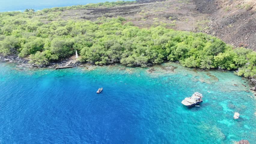 Stunning aerial drone footage of the Captain James Cook monument in Kealakekua Bay, Big Island, Hawaii.The monument marks the spot where James Cook was killed in a fight with native Hawaiians in 1779.