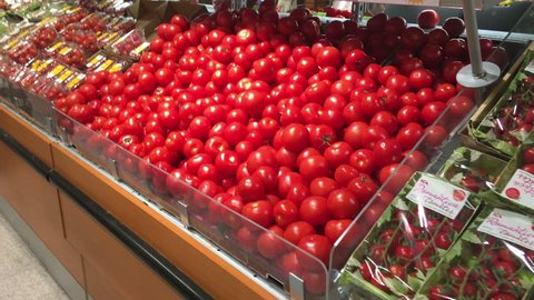 SWEDEN, EUROPE-CIRCA JUL, 2018: Fresh vegetables as tomatoes, cucumbers and other lay on grocery stand in Ica MAXI supermarket. ICA Gruppen AB is a Swedish retailer with wide range of products