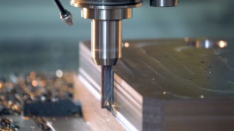 CNC milling machine in operation cutting steel in a high-tech machineshop