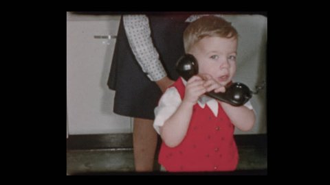 1955 Cute little boy on old fashioned telephone