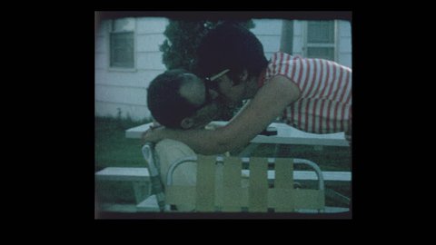 1964 Husband and wife smooching kissing