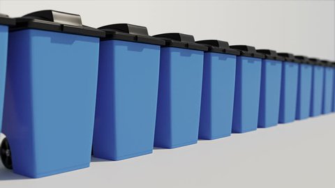 Blue trash containers with black flap standing in line - garbage concept 