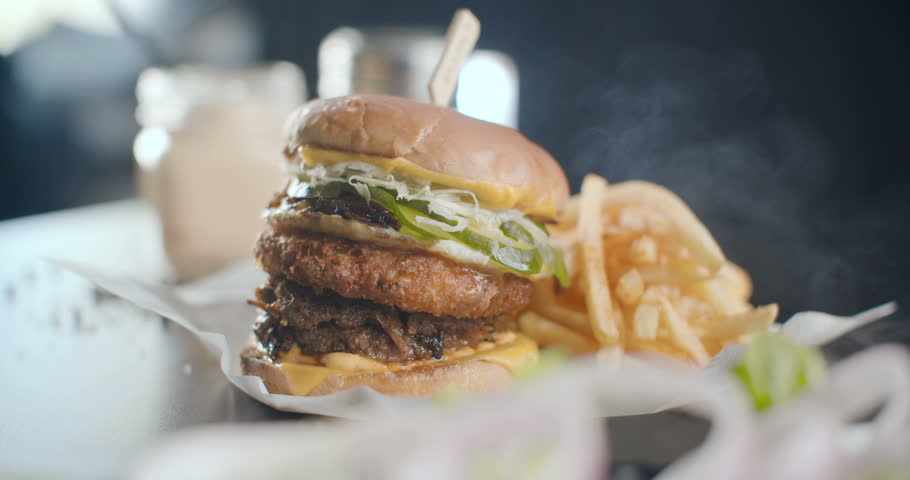 Great Burger with beef cutlet, chicken cutlet, cabbage, onion and cucumbers with melted cheese rotates served with french fries