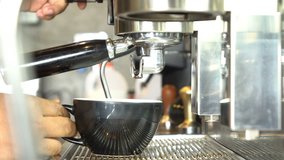 closeup barista is using a coffee maker machine in coffee shop cafe , preparing coffee latte art with espresso machine  steam - Video footage 4k