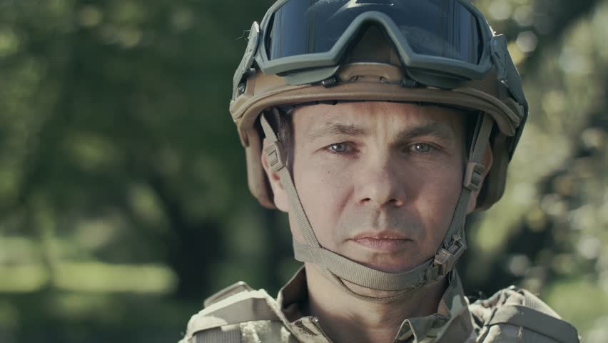 Portrait Of A Soldier. Sadness And Pity On The Face. Close-up.