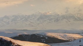 Russia, time lapse. Winter views of the snowy mountains of the Caucasus. Formation and movement of clouds over mountains peaks.