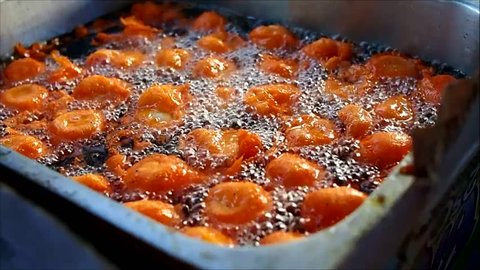 Video of deep fried quail eggs in a flour batter called "Kwek Kwek"