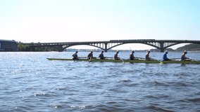 Rowing team summer training. 8 athletes rowers in a boat in the river Dnipro. City area in Kiev, Ukraine. Go Everywhere. Be H3althy - Powered by Shutterstock - Get 15% off with code: PIKWIZARD15