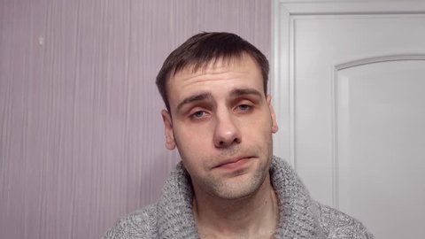 A adult man looking suspicious. Person lifts his eyebrow and do not really believe in the words he hears, looking a little bit gloomy.
