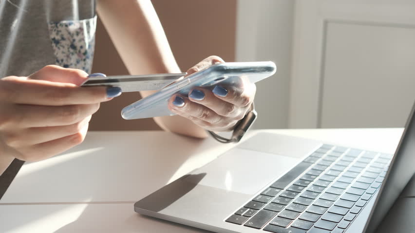 Online banking with smart phone. Lifestyle. Easy pay using smart phone or digital device. Communication via app for sale in shop. Woman shopping online on a sunny day with credit card. Hands close up | Shutterstock HD Video #1023583117