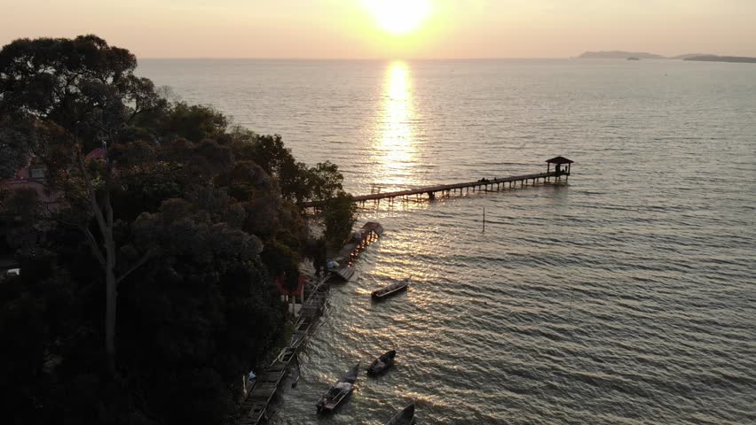Aerial view of seascape with sunset scenery. Drone hovering over the fishermen jetty.