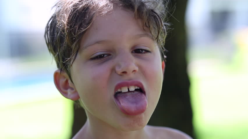 Child boy grimacing, misbehaving, sticking tongue out | Shutterstock HD Video #1023591754