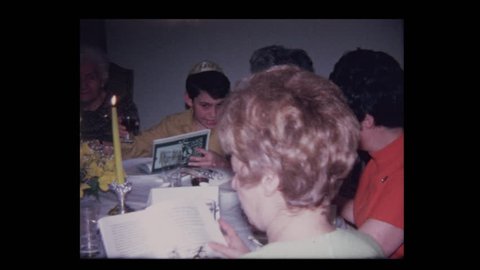 1971 Grandfather leads prayer over wine at Passover seder