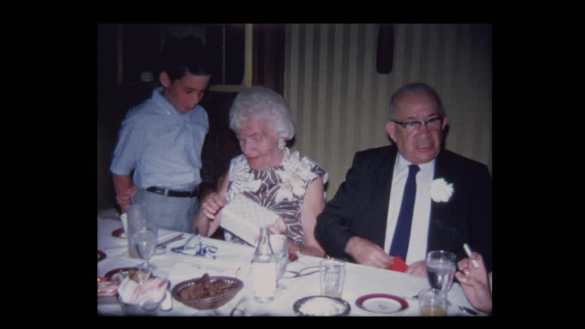 1971 Boy gives elderly grandparents funny gift at anniversary party